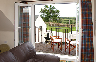 A view through the patio doors to the balcony - Glassdrumman Cottage